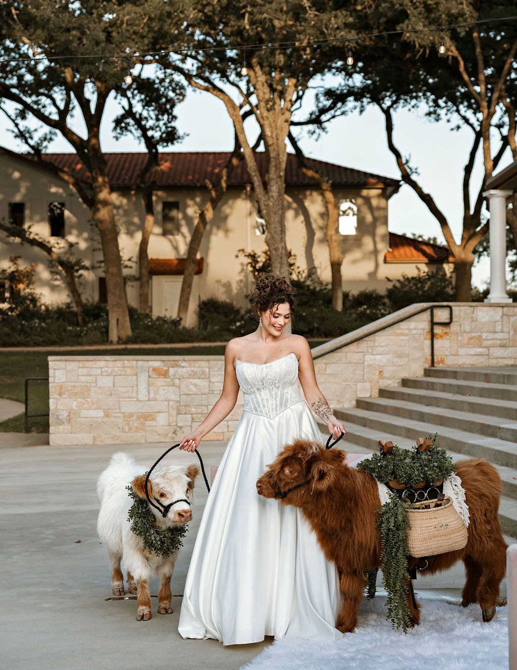 Bride with a Highland cow in a garden setting
